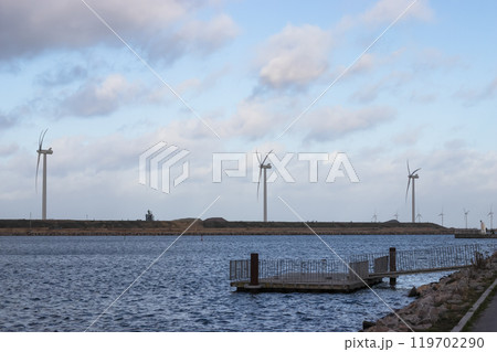 Wind turbine farm power genarator in beautiful nature landscape for production of renewable green energy. 119702290