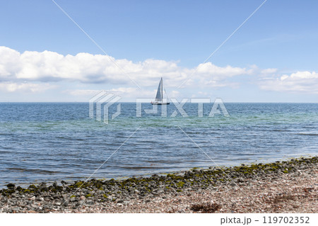 Beautiful seascape. Sailboat floats on the blue sea. Beautiful seascape. Sailboat floats on the blue sea. 119702352