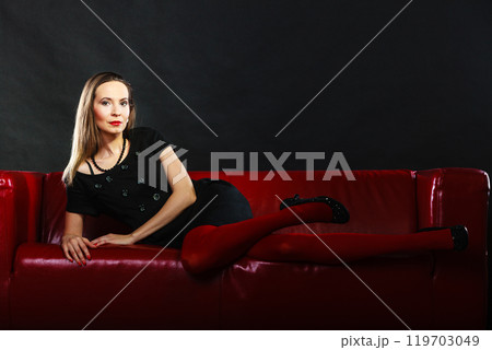 Fashion woman in red pantyhose on couch 119703049