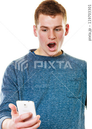 Surprised young man looking at mobile phone 119703301