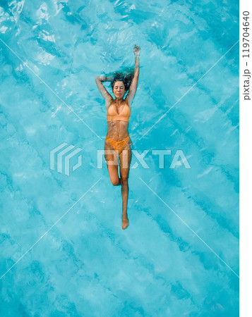 Slim beauty woman floating in tropical blue ocean. Aerial view, top down view. 119704640
