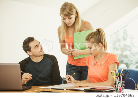 Students and teacher tutor in classroom 119704668