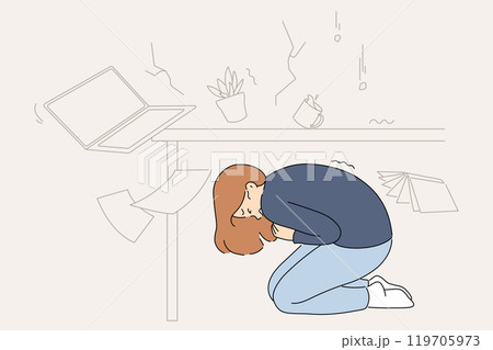 Earthquake frightened businesswoman who hid under table to escape falling objects 119705973