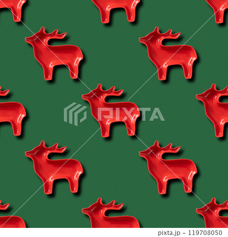 Seamless pattern of Christmas red reindeer on green background. Xmas abstract wallpaper. Seamless pattern of Christmas red reindeer on green background. Xmas abstract wallpaper. 119708050