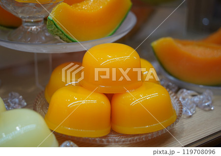 Mango pudding with melon on display in a shop window Mango pudding with melon on display in a shop window 119708096