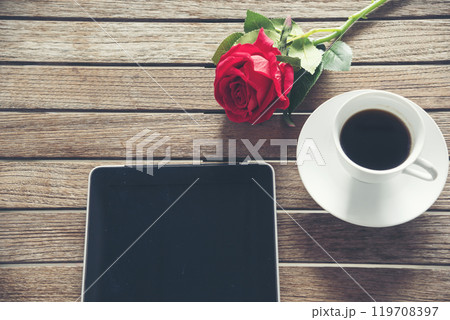 Top view office desk smart tablet document paper, coffee cup roses on wood table with copy space. Tabletop notebook office empty blank white paper pen coffee cup to display workspace wood background 119708397