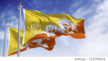 Close-up of two Bhutan national flags waving in the wind. 119708628