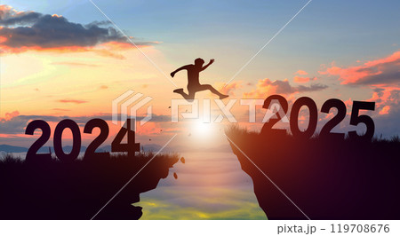 Welcome merry Christmas and Happy new year in 2025. Man jumping across the gap from 2024 to 2025 cliff with Sunset and Twilight Sky background. 119708676