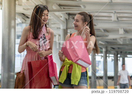 Shopaholic Women holding shopping bags ,money ,credit card person at shopping malls.Fashionable Woman love online website with sales tag on black Friday. E-commerce fashion digital marketing lifestyle 119708720