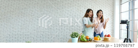 Banner Asian influencer vlogger live review healthy eating lifestyle. Banner Two woman friends blogger vlog happy lifestyle vegetables fruit salad. Two women talk social media vlog with copy space 119708797