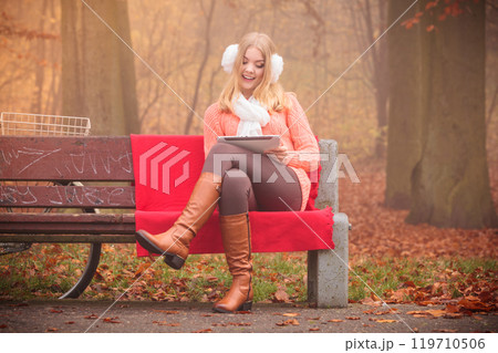 Lady with tablet in park. 119710506