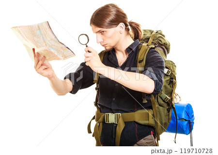 Man tourist reading map with magnifying glass Man tourist reading map with magnifying glass 119710728