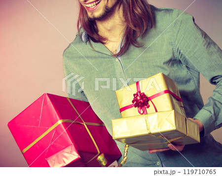 Guy with many presents gift boxes 119710765