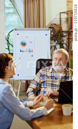 Teamwork and collaboration are at center of this business meeting, where professionals discuss strategies and goals. 119710828