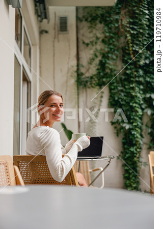 A Woman Absolutely Enjoying Her Hot Coffee While in a Cozy Indoor Setting Around Her 119710984