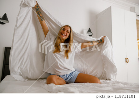 A Blissful and Joyful Morning Moment in a Brightly Lit and Inviting Bedroom Space A Blissful and Joyful Morning Moment in a Brightly Lit and Inviting Bedroom Space 119711101