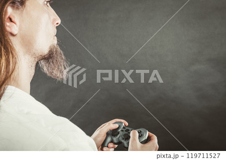 Male player focus on play games Male player focus on play games 119711527