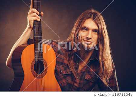 Young man holding guitar. Young man holding guitar. 119711549