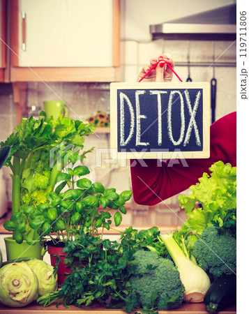 Woman having green diet vegetables, detox sign 119711806