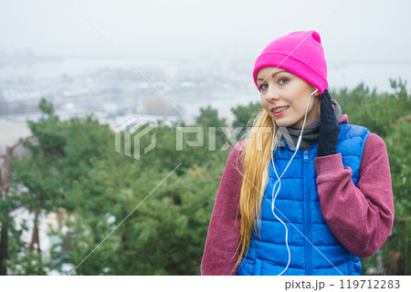 Woman wearing sportswear exercising outside during autumn Woman wearing sportswear exercising outside during autumn 119712283