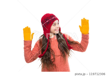 Teen girl in hat enjoying childhood. Girl wearing trendy outfit with knitted beanie hat. Girl with winter hat isolated on white. Winter fashion style trend. Thermal mittens 119712306