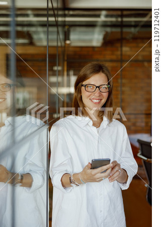 A Confident Professional Woman Thriving in a Modern Office Setting, Radiating Success and Leadership 119712401