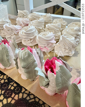 Homemade marshmallows on the table surface. They are setting and stabilizing before packaging. The marshmallows are classic. Marshmallow tulips. Homemade marshmallows on the table surface. They are setting and stabilizing before packaging. The marshmallows are classic. Marshmallow tulips. 119713553