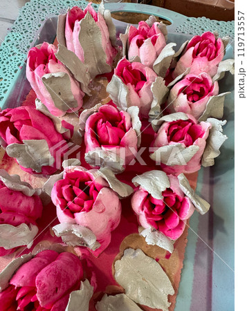 Bright pink marshmallow tulips. Marshmallow flowers. Spread out on the table surface. 119713557