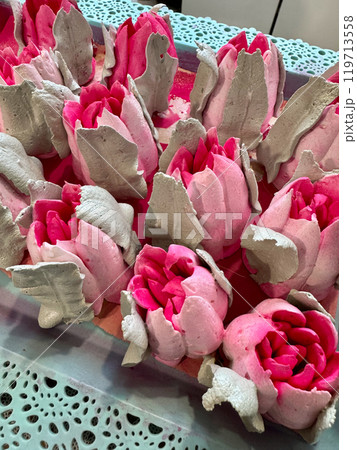 Bright pink marshmallow tulips. Marshmallow flowers. Spread out on the table surface. Bright pink marshmallow tulips. Marshmallow flowers. Spread out on the table surface. 119713558