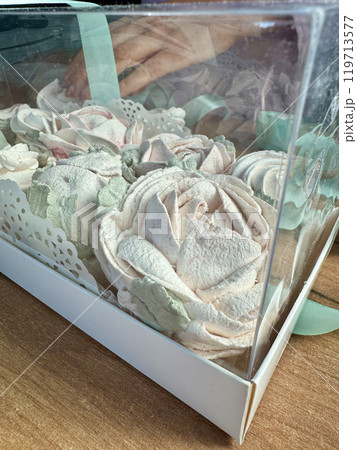 Marshmallow flowers in a gift box with a transparent lid. Homemade marshmallows as a gift. Close-up. Marshmallow flowers in a gift box with a transparent lid. Homemade marshmallows as a gift. Close-up. 119713577