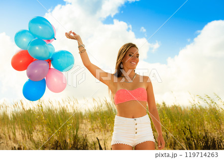 Girl holding balloons sky background Girl holding balloons sky background 119714263
