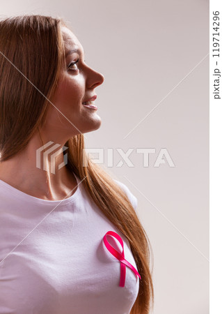 Woman wih pink cancer ribbon on chest 119714296