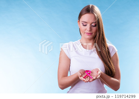 Woman with breast cancer awareness ribbon on hands 119714299