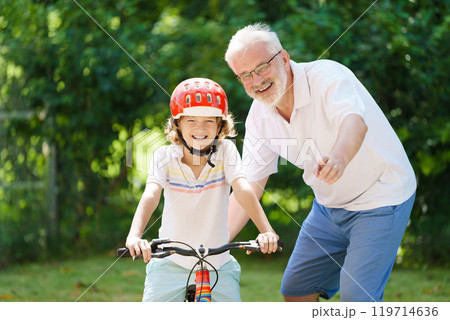 Grandfather and kids in sunny garden Grandfather and kids in sunny garden 119714636