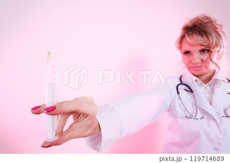 Blonde doctor with syringe. 119714689