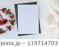 Blank Christmas Card with Holly Wreath and Knit Fabric for Festive and Winter Holiday Designs. Christmas mockup 119714703