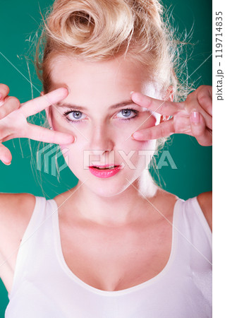 Woman with fingers close to eyes Woman with fingers close to eyes 119714835