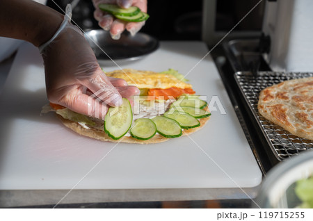 Chef prepares flatbread with salmon. Quesadilla.  119715255