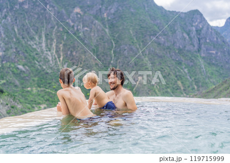 Father with his toddler and teenage sons bathing in the hot springs of Grutas Tolantongo, Mexico. Family adventure, relaxation, and natural wellness concept 119715999
