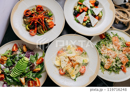 Assorted gourmet salads with ingredients like avocado, smoked salmon, feta and grilled vegetables Assorted gourmet salads with ingredients like avocado, smoked salmon, feta and grilled vegetables 119716248