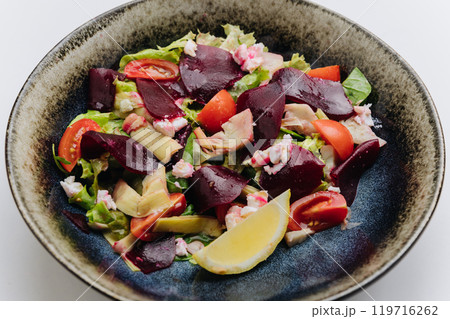 Healthy beetroot salad with fresh tomatoes, feta, and lemon for a nutritious and flavorful meal Healthy beetroot salad with fresh tomatoes, feta, and lemon for a nutritious and flavorful meal 119716262