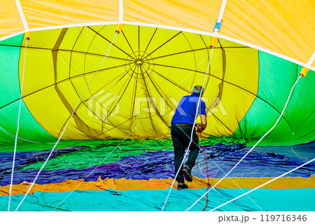 Colorful hot air balloon flying over blue sky with white clouds	 119716346