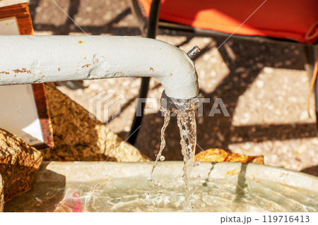 Water pours from a water column in the city of Nitra in Slovakia. Spring clean water. 119716413
