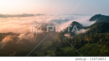 Aerial View of Morning fog and mountains as the sun rises from above 119718651