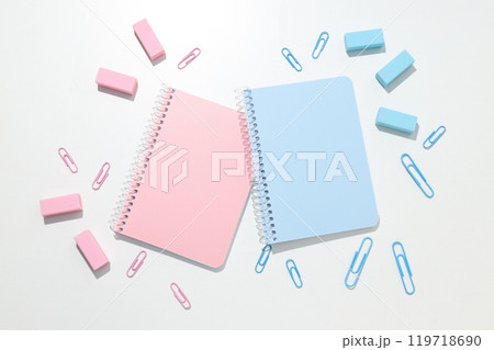 Blue and pink notebooks with stationery on a white background Blue and pink notebooks with stationery on a white background 119718690