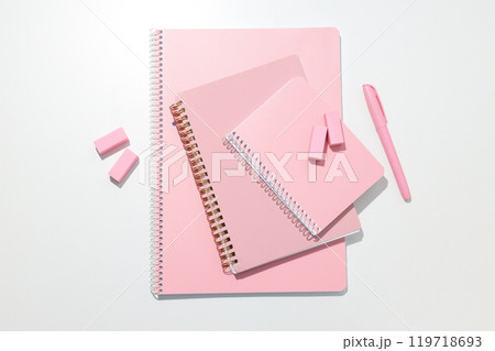 Pink notebook with stationery on a white background Pink notebook with stationery on a white background 119718693