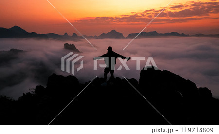 Man standing on the mountain and sea view with mountains in the early morning Man standing on the mountain and sea view with mountains in the early morning 119718809
