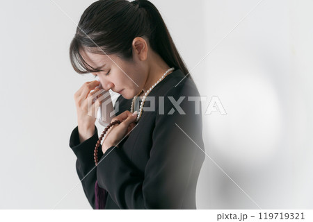 涙を流す喪服の女性 119719321
