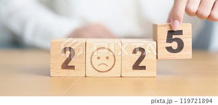 Happy New Year 2025 with Sad face block. Satisfaction, feedback, Review, mental health, eco sustainable and bad year concept 119721894
