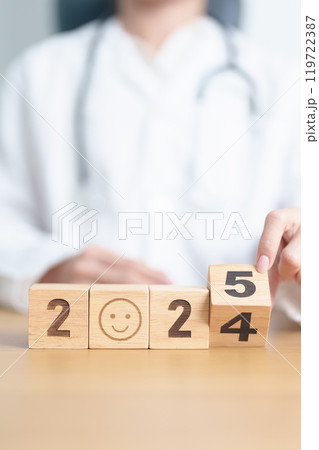 2024 end year to Happy New Year 2025 with Smile block against doctor. Health, Healthcare insurance, medical Satisfaction, feedback, Review, mental health, wellbeing, wellness and good year concept 119722387